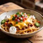 Overhead shot of cheesy Taco Spaghetti topped with cilantro and sour cream
